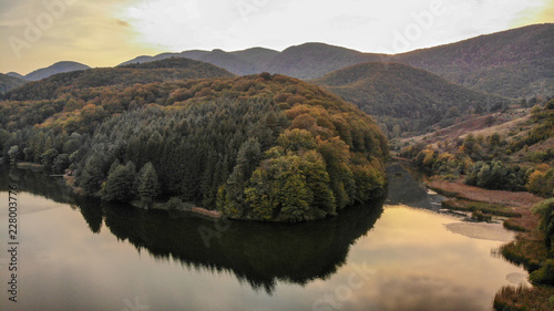Aerial view of sunset on Minis lake in Romania. National park Cheile Nerei Beusnita in Carpathian mountains.