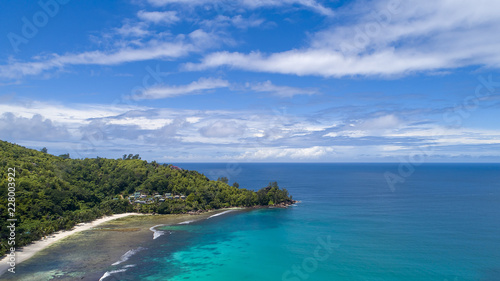Tropical beach with sea and palm taken from drone. Beach and sea photo. Romantic beach aerial view. © gawriloff