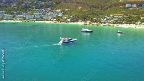 fly around yachts arriving at beautiful beach