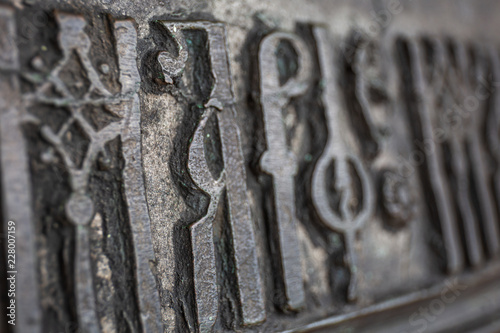 Close-up of ancient Slavic letters on ancient bronze bell in orthodox church in Rostov the Great