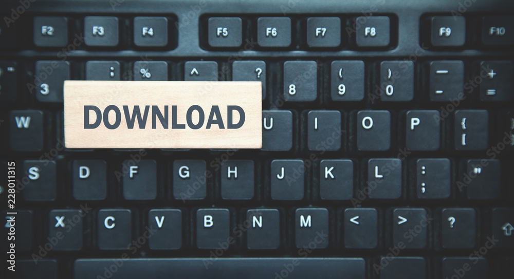 Word Download on wooden block. Black keyboard background Word Download on wooden block. Black keyboard background