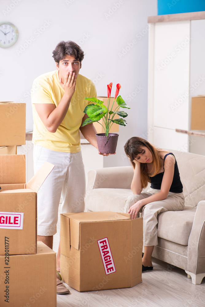 Young couple moving to new flat with fragile things Young couple moving to new flat with fragile things
