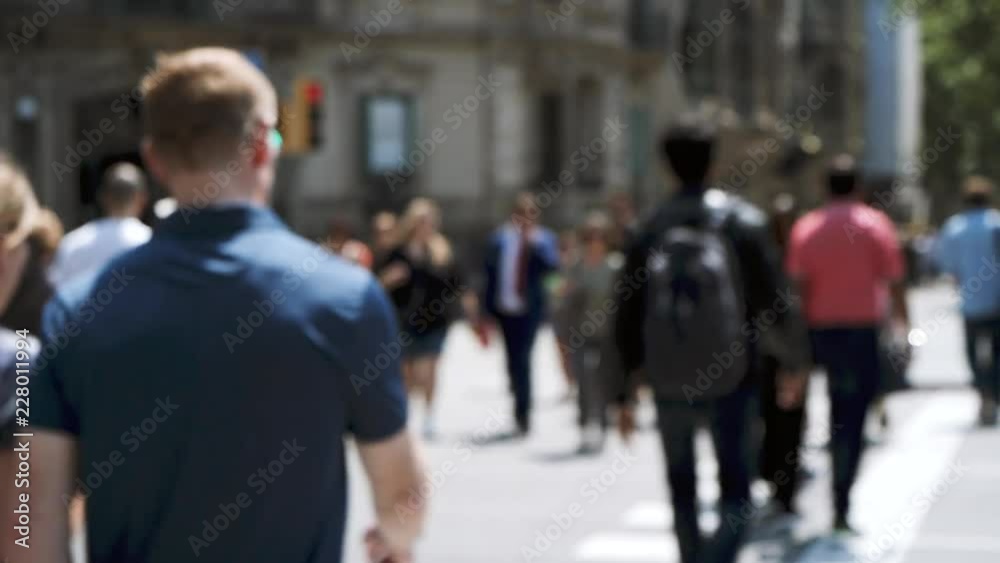 Defocused view city atmosphere with adults and seniors people crossing busy intersection in central Barcelona crossroads passage Defocused view city atmosphere with adults and seniors people crossing busy intersection in central Barcelona crossroads passage