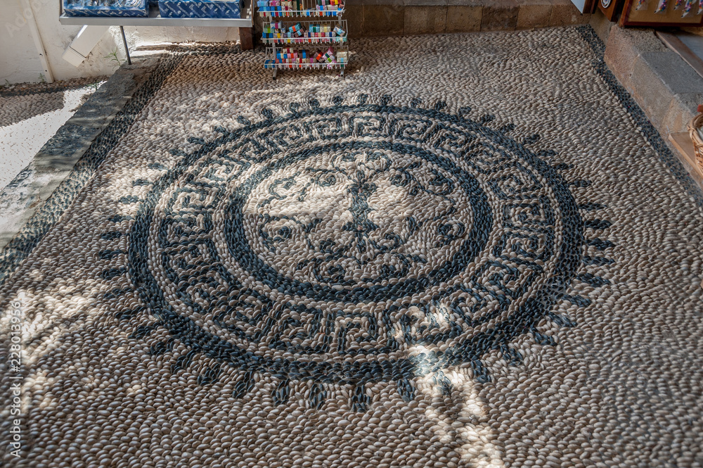 Pebble stone mosaic. Pavement. Lindos Town. Greek Island of Rhodes.