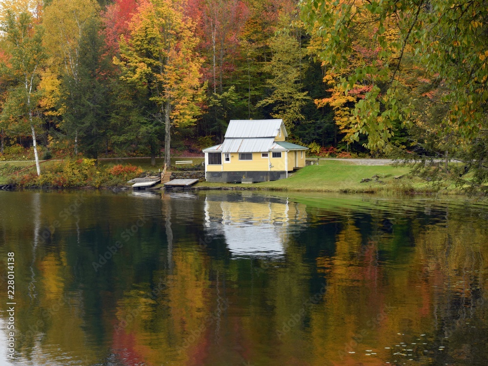 Yellow Cabin Reflection on Calm Autumn Lake