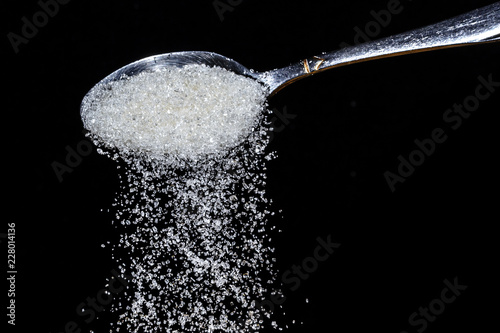 teaspoon with sugar dunes and granulated sugar