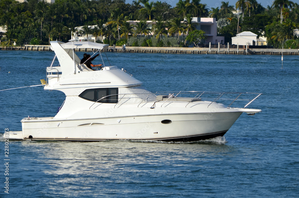 Sport fishing boat cruising past Rivo Alto in Miami Beach,Florida