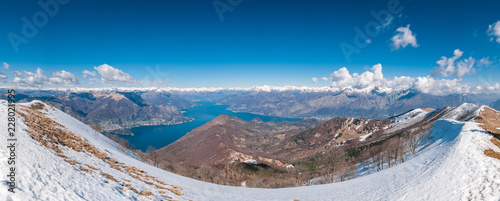 Panoramic view of lake Como and surrounding mountains as seen from Monte San Primo summit