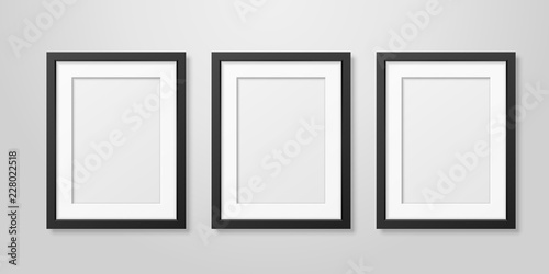 Three Vector Realistic Mofern Interior Black Blank Vertical A4 Wooden Poster Picture Frame Set Closeup on White Wall Mock-up. Empty Poster Frames Design Template for Mockup, Presentation