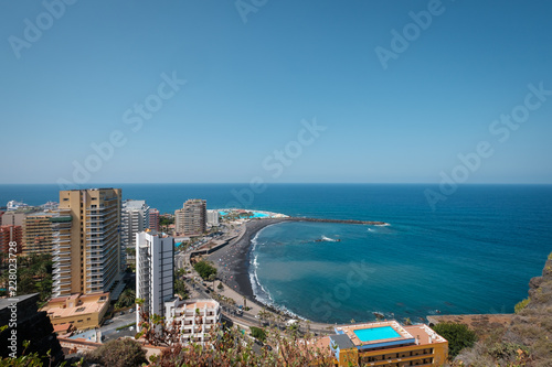 City and beach aerial of Puerto de la Cruz with ocean horizon background