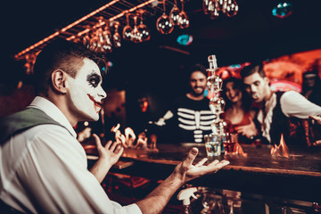 Bartender in Halloween Costume Making Cocktail