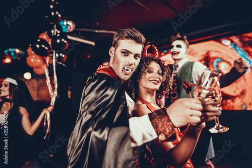 Young Happy Couple in Costumes at Halloween Party