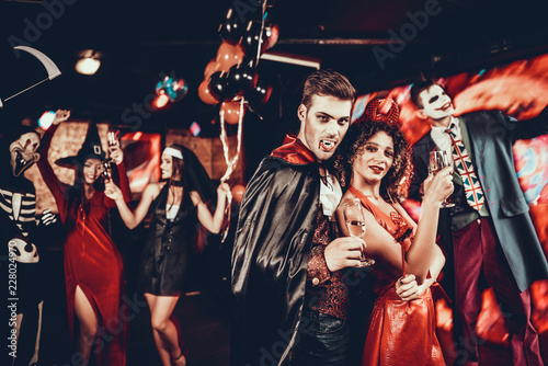 Young Happy Couple in Costumes at Halloween Party