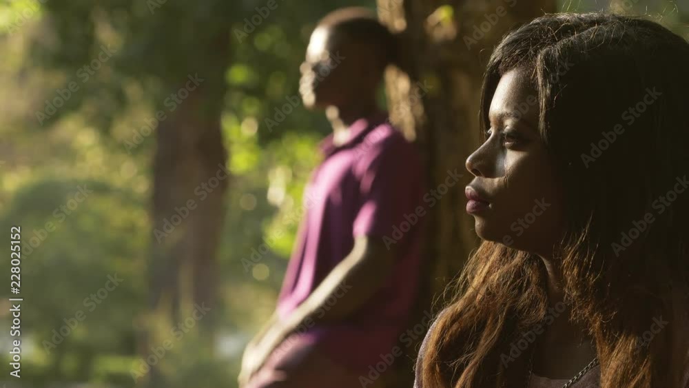 black couple angry couple at the park. incommunicability, anger, silences