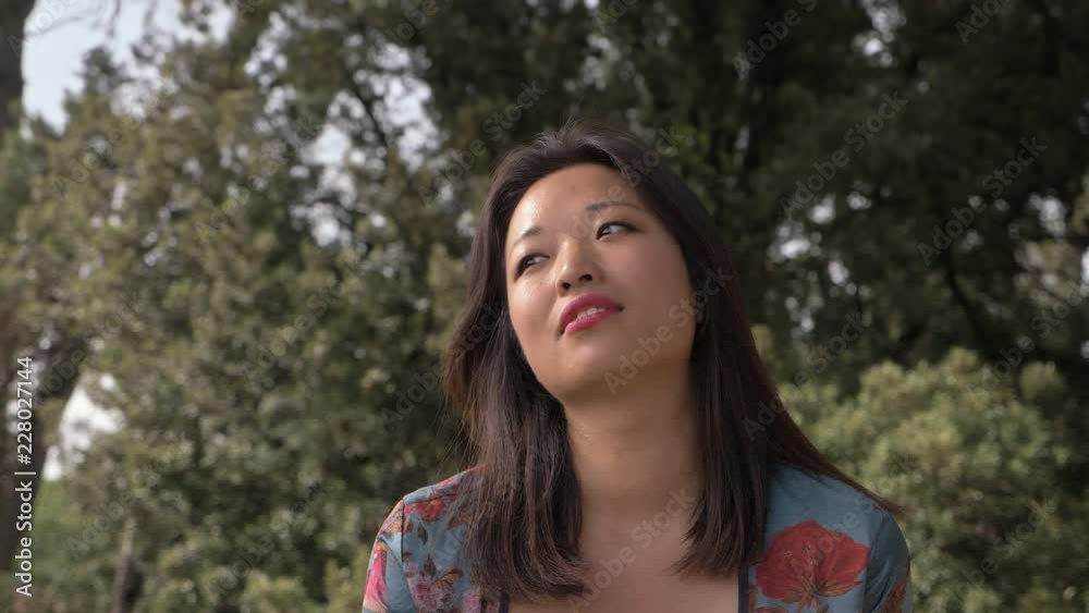 hot emergency in the city: sensual young asian woman using fan in the park hot emergency in the city: sensual young asian woman using fan in the park