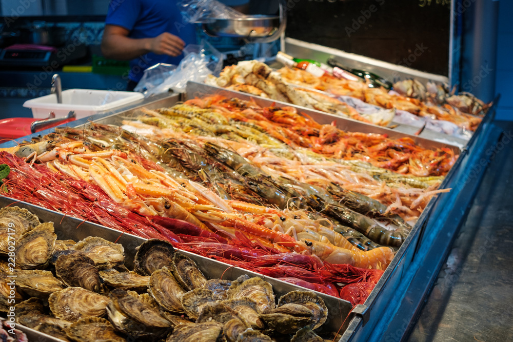 fresh  shrimps, crabs and seafood on ice at fish market stand
