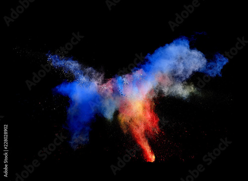 Bizarre forms of powder paint and flour combined  together explode in front of a black background to give off fantastic  multi colored cloud forms.