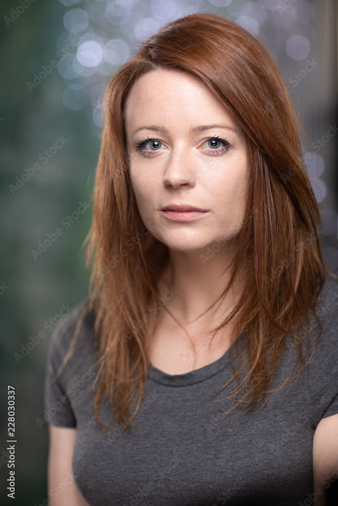 Portrait of white skin ginger girl with blue eyes with dark grey t shirt Portrait of white skin ginger girl with blue eyes with dark grey t shirt
