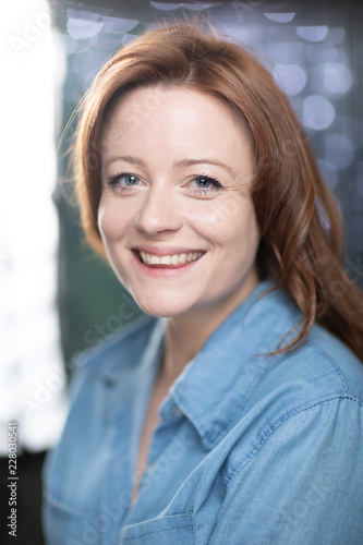 Portrait of white skin ginger girl with blue eyes with denim shirt