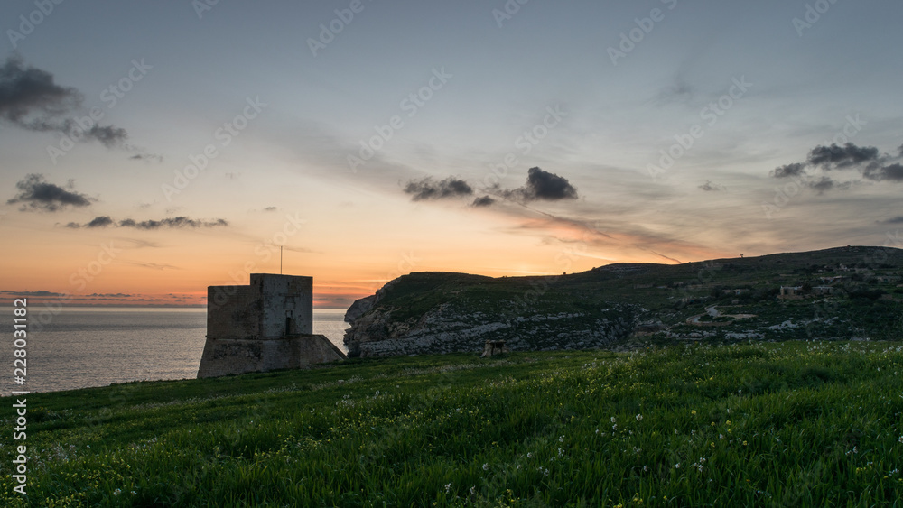 Mgarr Ix-Xini Bay Tower Gozo. Malta. Horizontal at sunset