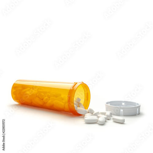 Open orange pill bottle with pills on white background