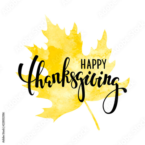 happy thanksgiving on yellow watercolor maple leaf. Hand drawn calligraphy and brush pen lettering. design for holiday greeting card and invitation of seasonal american and canadian autumn holiday
