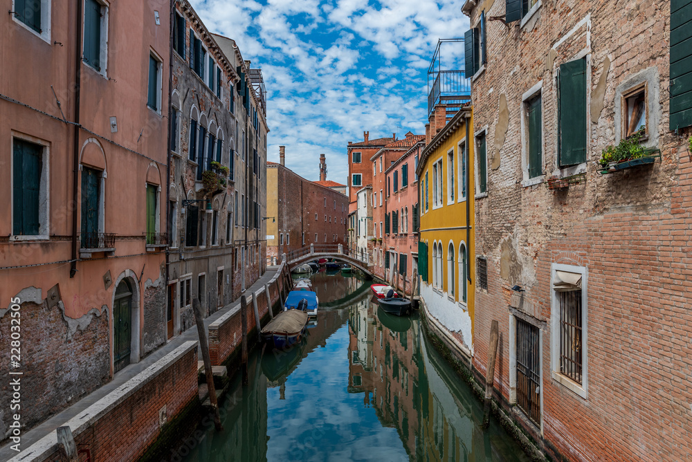 Typical street of Venice. Motorboats moored not far from the central water street without tourists, Italy