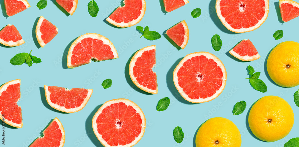 Halved fresh grapefruits on bright color background Halved fresh grapefruits on bright color background