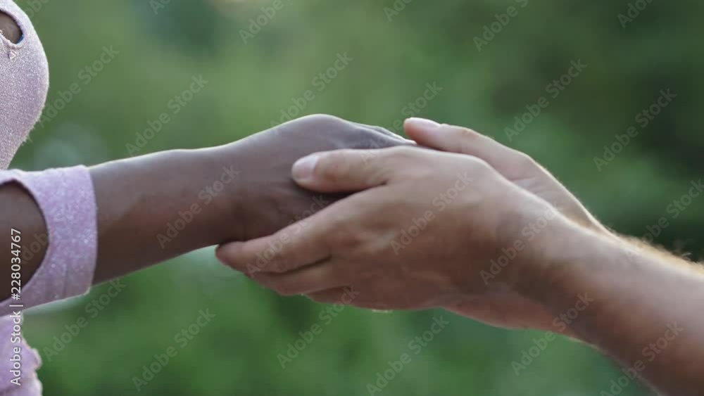 hands of white man caress hand of black woman.Cure, affection, love hands of white man caress hand of black woman.Cure, affection, love