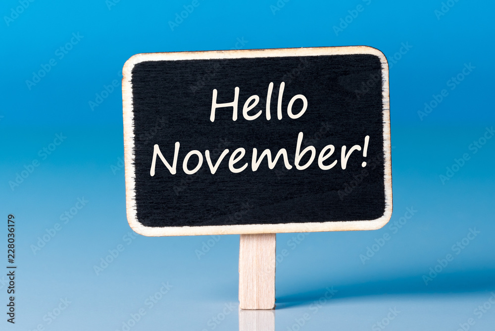 Hello November on Small wooden framed blackboard at blue background Hello November on Small wooden framed blackboard at blue background