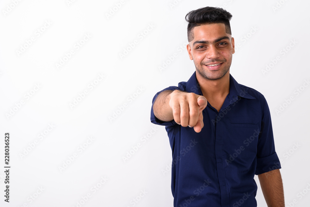 Naklejka premium Studio shot of young Indian businessman against white background