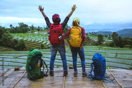 Lover woman and man Asian travel nature. Travel relax. Viewpoint Rice field of the field on the Moutain papongpieng in summer. Thailand. photo