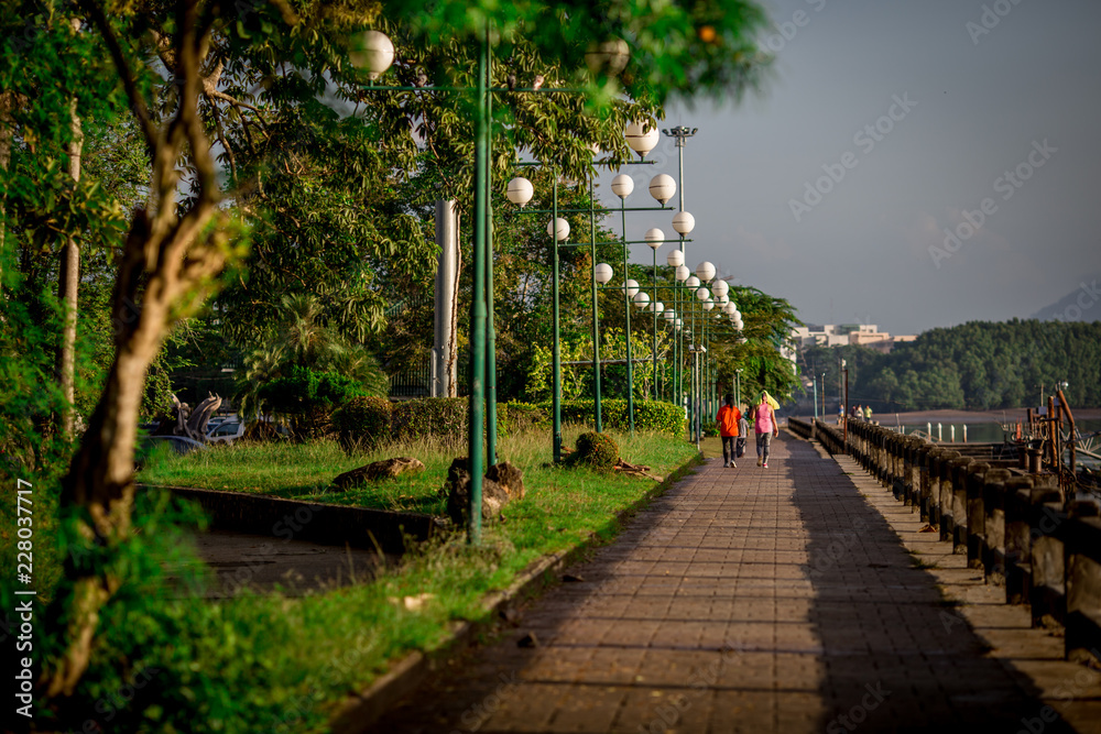 Naklejka premium Chaofah Park, the morning, people jogging, in the harbor area, the waterfront community, Tourist Infomation Building, is a landmark. And can be used in the city of Krabi, Thailand.