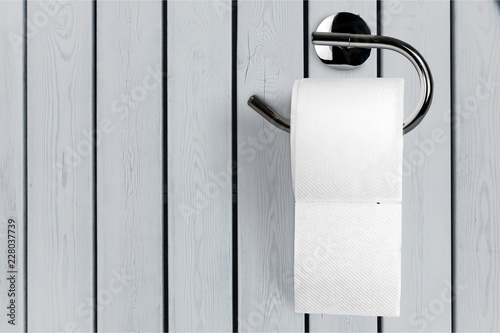 Roll of white toilet paper on metal