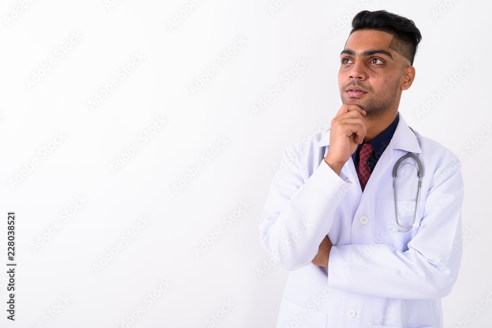 Young Indian man doctor against white background Young Indian man doctor against white background