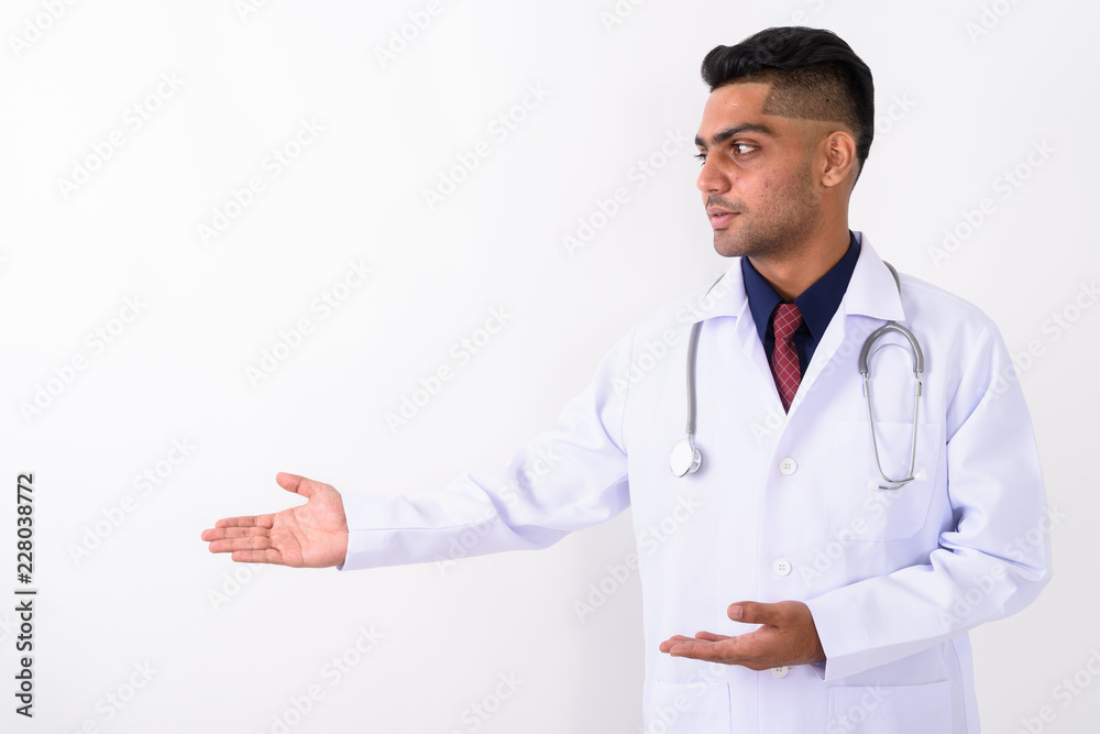 Young Indian man doctor against white background Young Indian man doctor against white background