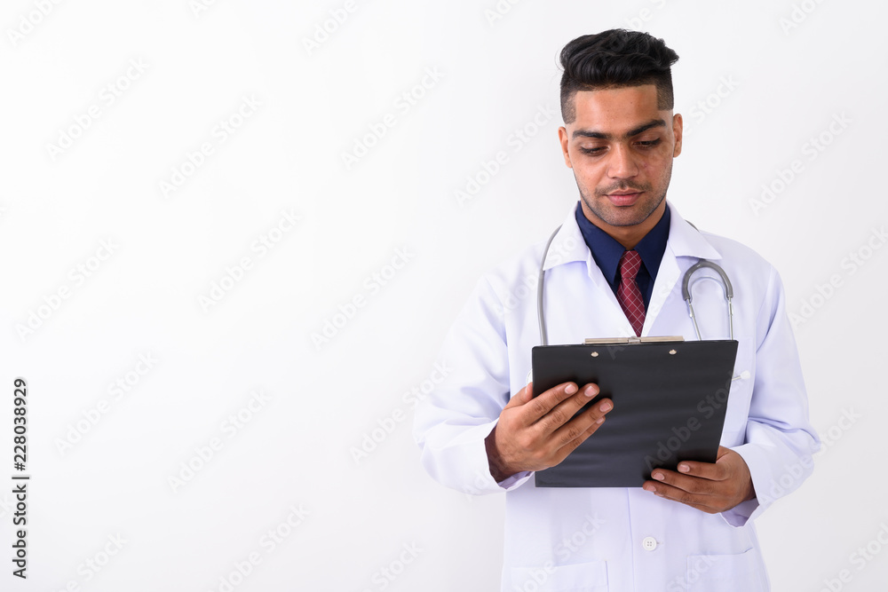 Young Indian man doctor against white background Young Indian man doctor against white background