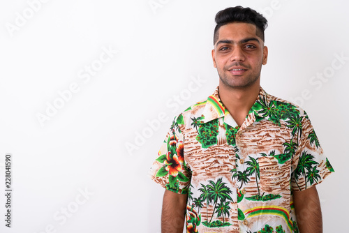 Wallpaper Mural Young Indian tourist man wearing Hawaiian shirt against white ba Torontodigital.ca