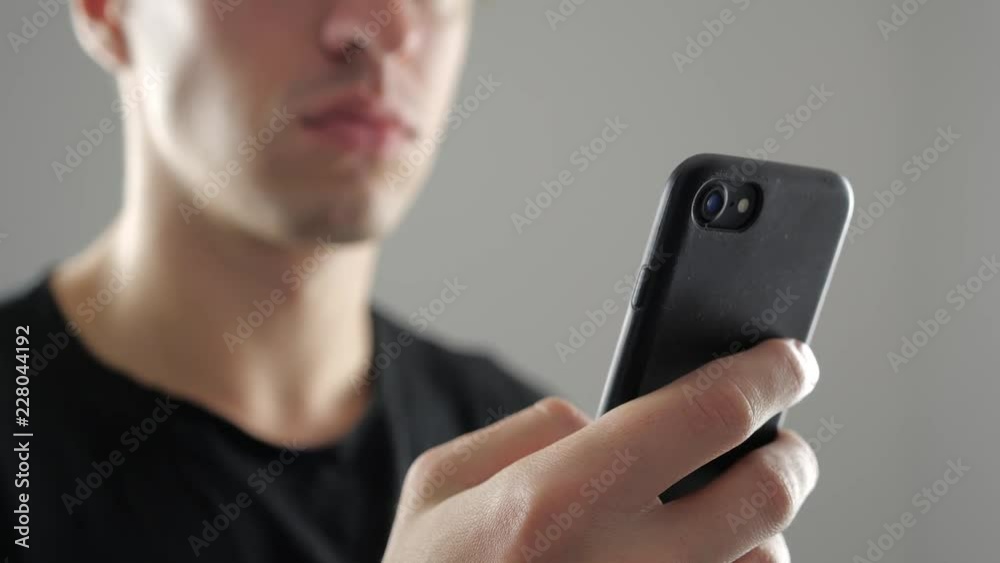 Closeup of Young Man Using Smartphone, Browsing in Internet or Checking Social Networks