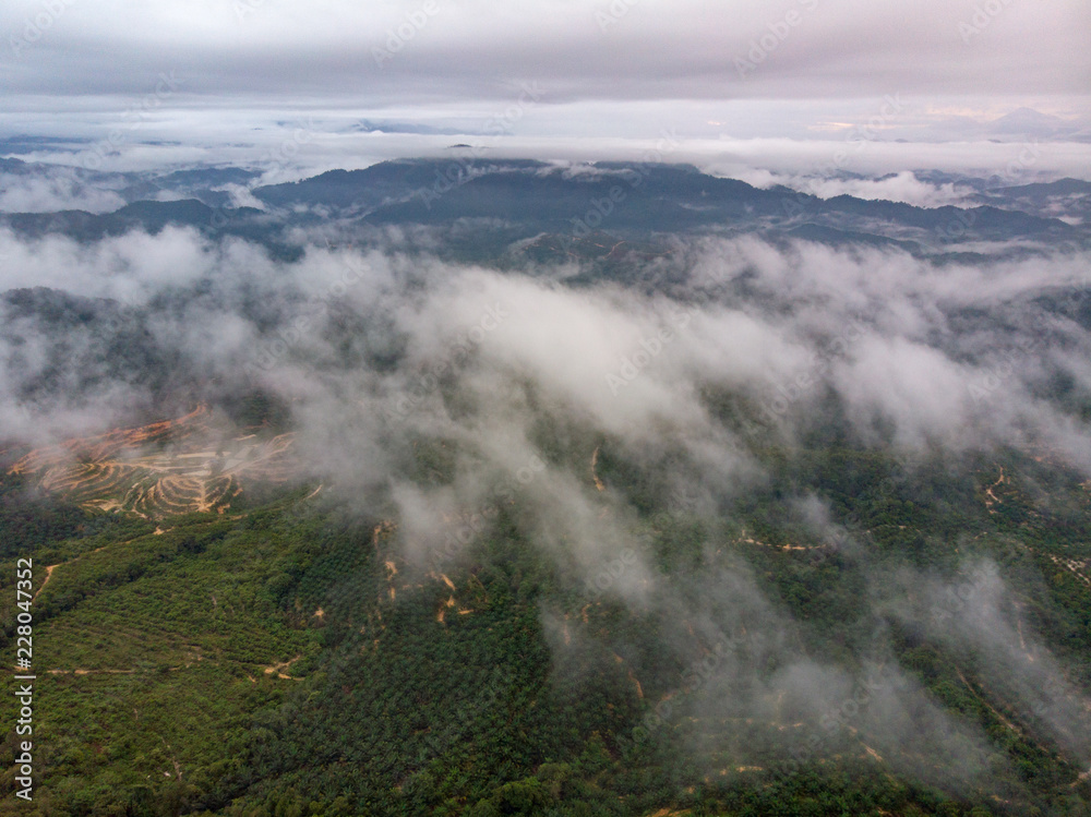 Aerial view of mountain with cloudy background.
