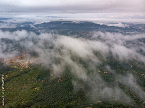 Aerial view of mountain with cloudy background.