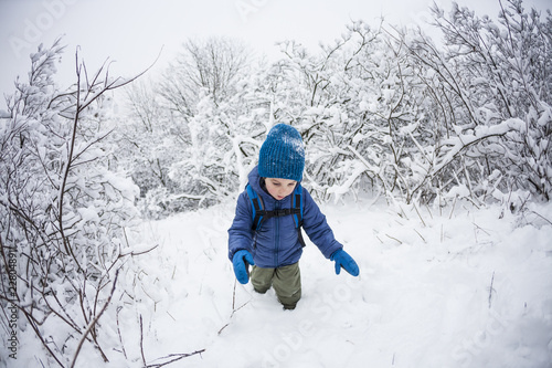 A child runs through the snow.