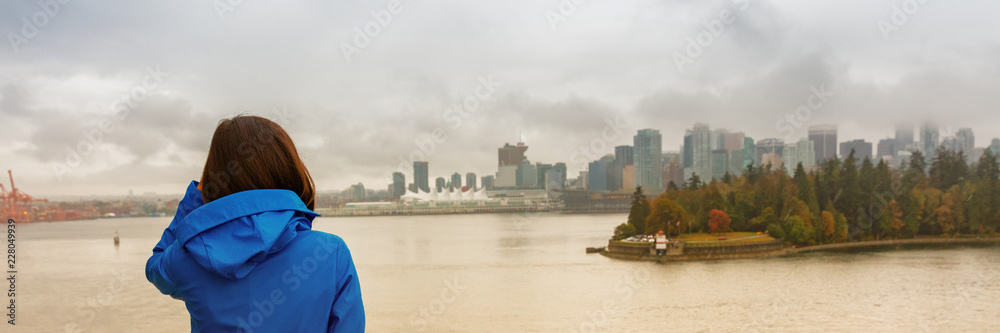 Vancouver city lifestyle woman looking at Coal Harbour, British Columbia, Canada travel. tourist student in city outdoors enjoying autumn season banner panorama.