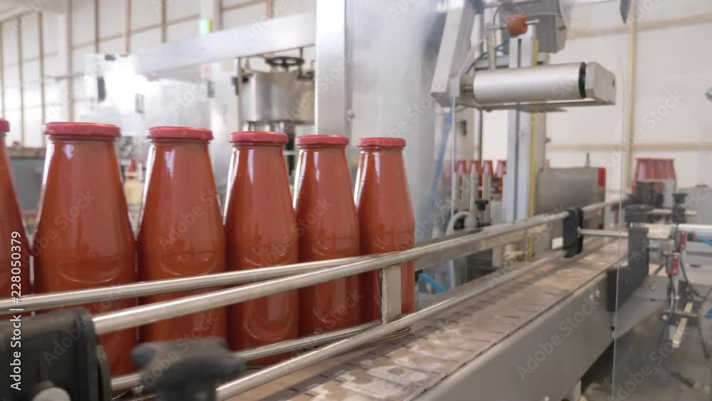Tomato Sauce factory,production. Tomato sauce bottles on conveyor line Tomato Sauce factory,production. Tomato sauce bottles on conveyor line