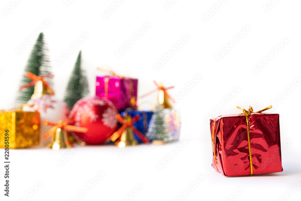 Christmas red gift box. Christmas gift box and tree with golden bells, pine cones, red and white ball on white background