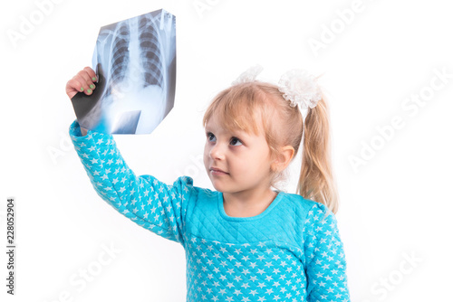 A child, a little girl, examines an X-ray.