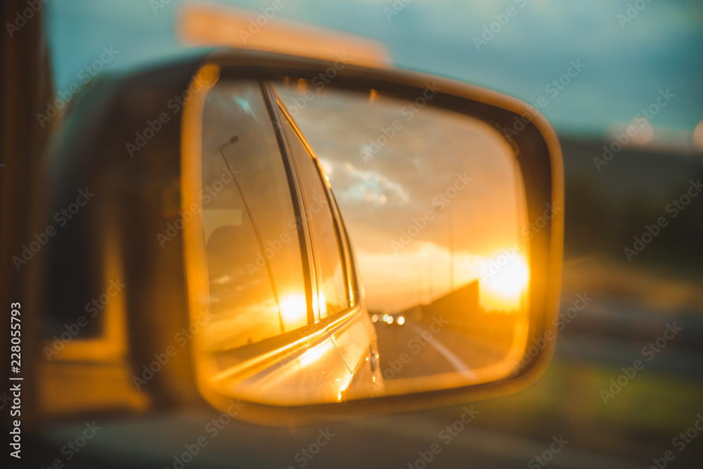 car on highway. sunset in car mirror reflection car on highway. sunset in car mirror reflection