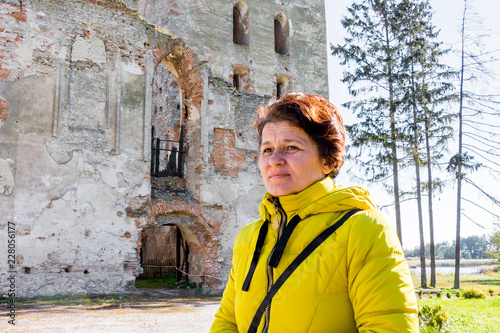 Woman on the background of an ancient castle during a tour_ photo