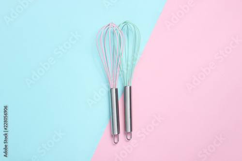Two whisk on blue pink pastel background. Top view, minimalism. Fototapet