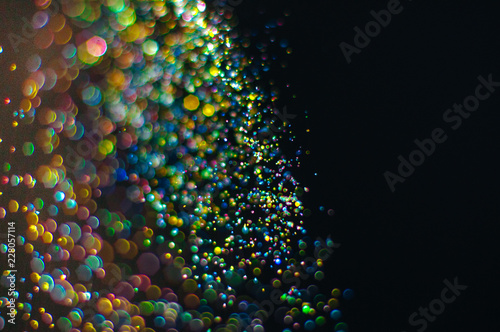 Abstract background with glittering color particles with copy space